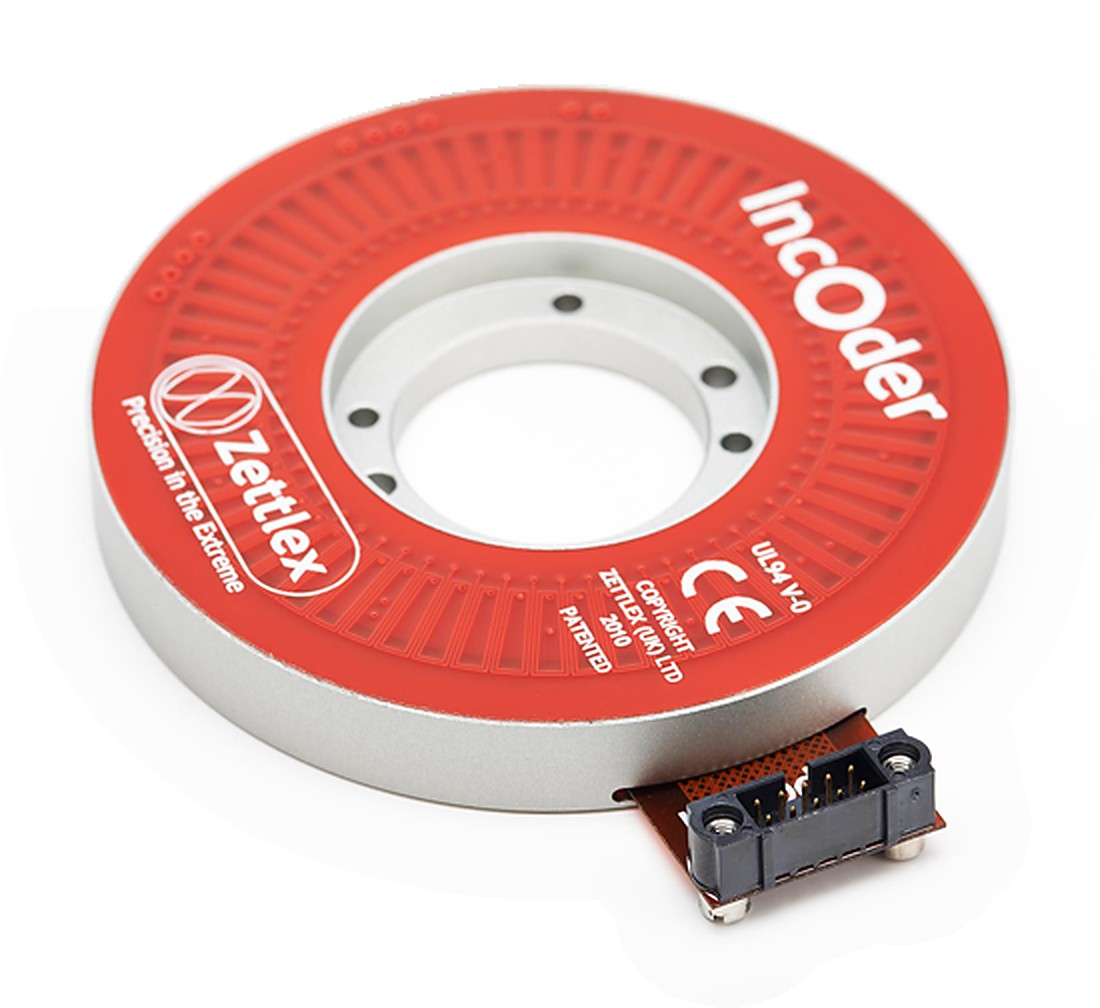 A Zettlex IncOder inductive encoder: a red and silver ring with a PCB read head