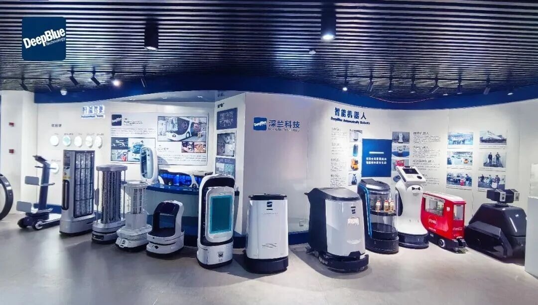 A robot company exhibition booth with rows of cleaning and disinfection robots on display